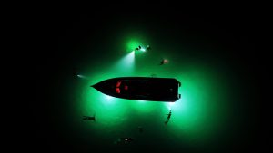 illuminated boat in the sea ready for a night swim